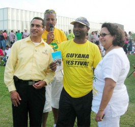 Caribbean Airlines Sales Executive Nazie Mohammed (left) poses with Captain of the winning cricket team Roy Moosaie (centre) and Consul General of Guyana Sattie Sawh (right). Standing behind them is one of the commentators. (Photo courtesy of Caribbean Airlines)