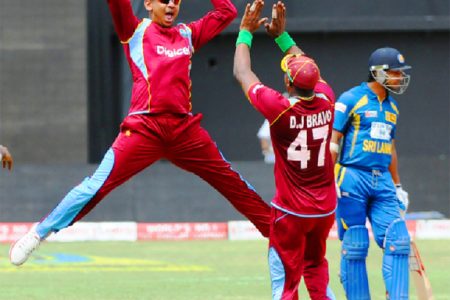 OVERJOYED!West Indies spinner Sunil Narine and captain Dwayne Bravo celebrate the wicket of Mahela Jayawardene. WICB Media Photo