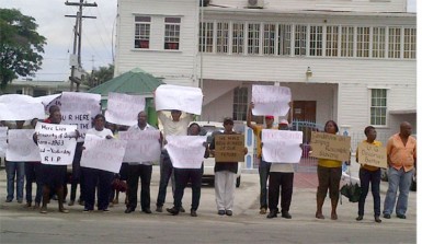 University of Guyana staffers protest in front of the Ministry of Education yesterday