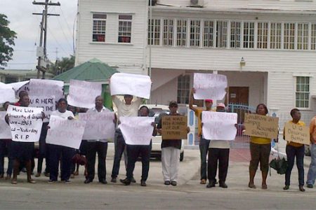 University of Guyana staffers protest in front of the Ministry of Education yesterday