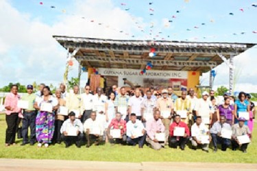 Minister of Agriculture, Dr. Leslie Ramsammy, GuySuCo officials and the workers pose in this GINA photo. 