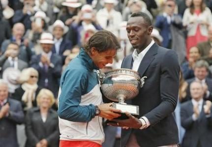 Rafael Nadal (L) of Spain receives the trophy from Jamaican sprinter Usain Bolt after defeating compatriot David Ferrer in their men's singles final match to win the French Open tennis tournament at More...
Credit: REUTERS/Gonzalo Fuentes