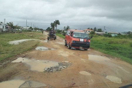 A bus manoeuvring through the many potholes in the main road leading into ‘C’ Field Sophia