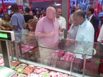 Geert van Dijk (Left) explains to Minister Leslie Ramsammy what goes into the preparation of the meat on display