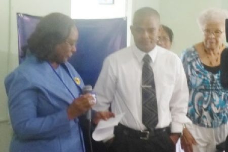President Sherlock Reece (centre) and officials of the Foundation at the handing over ceremony