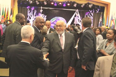 President Donald Ramotar  (centre) greeting an invitee at the Opening Ceremony of the Heads of Caricom Summit in Trinidad and Tobago on Wednesday. (Neilon A Dias photo) 