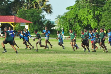 National Under-19 rugby captain Godfrey Broomes (with ball) in action during a recent simulation game at the National Park Rugby field.
