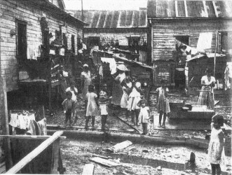 A tenement yard in the 1950s (from ‘British Guiana: Land of Six Peoples’ by Michael Swan, 1957)