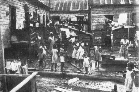 A tenement yard in the 1950s (from ‘British Guiana: Land of Six Peoples’ by Michael Swan, 1957)