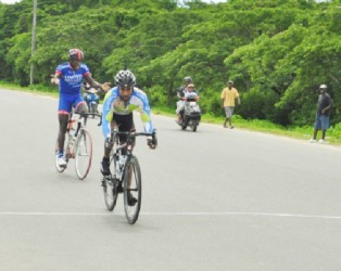 Robin Persaud edges last year’s Road Race champion, Orville Hinds to take yesterday’s annual 4th annual Seven Seas Multivitamins and Dr. Chase Nerve Foods 50-mile road race on the West Demerara (Orlando Charles photo) 