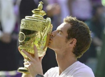 Andy Murray of Britain kisses the winners trophy after defeating Novak Djokovic of Serbia in their men's singles final tennis match at the Wimbledon Tennis Championships, in London yesterday. REUTERS/Toby Melville