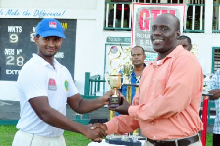 Man of the match in the finals for his century, Brian Sattaur receiving his trophy from match referee, Colin Stuart.
