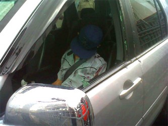 Victor Da Silva slumped in the front passenger seat of the car after he was shot dead by bandits  yesterday morning