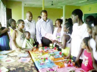 Minister of Culture, Youth and Sport, Dr. Frank Anthony (centre) interacts with children at a summer camp on the East Coast Demerara. (GINA photo) 