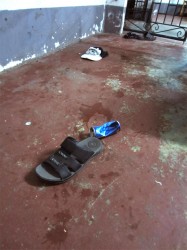 Blood stains were not yet cleaned up at the scene of the incident. The men ran out of the restaurant in an attempt to flee police leaving behind a pair of slippers, a bloody cap and an old bandana. 