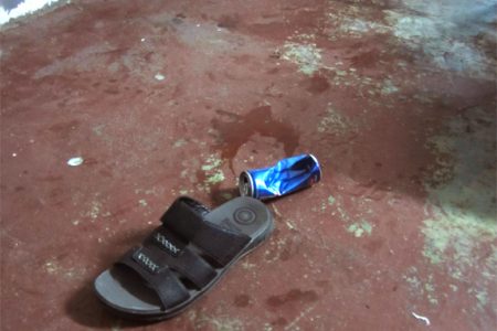 Blood stains were not yet cleaned up at the scene of the incident. The men ran out of the restaurant in an attempt to flee police leaving behind a pair of slippers, a bloody cap and an old bandana. 