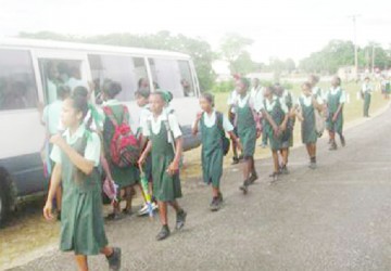 Children of the Dora Secondary school, prepare to board one of the buses provided to shuttle them between home and school under the School Retention Programme implemented via the Tackle Pilot Project to stop child labour by keeping children in the school system. 