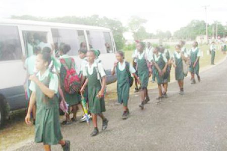 Children of the Dora Secondary school, prepare to board one of the buses provided to shuttle them between home and school under the School Retention Programme implemented via the Tackle Pilot Project to stop child labour by keeping children in the school system. 
