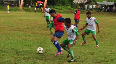 Jamal James of Port Kaituma defending the ball against a North West Secondary attack.