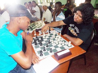 The two winners of the recent 2013 Trophy Stall Chess Tournament are pictured here during their individual encounter. At left is Taffin Khan and his opponent is Anthony Drayton. Taffin won the senior category of the tournament, while Anthony emerged victorious among his junior counterparts. Taffin won their individual clash. 