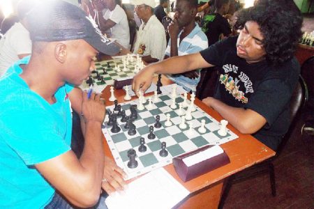 The two winners of the recent 2013 Trophy Stall Chess Tournament are pictured here during their individual encounter. At left is Taffin Khan and his opponent is Anthony Drayton. Taffin won the senior category of the tournament, while Anthony emerged victorious among his junior counterparts. Taffin won their individual clash.
