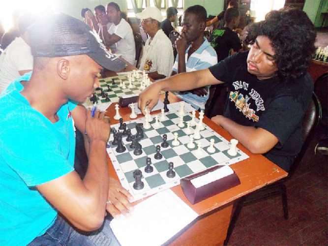 The two winners of the recent 2013 Trophy Stall Chess Tournament are pictured here during their individual encounter. At left is Taffin Khan and his opponent is Anthony Drayton. Taffin won the senior category of the tournament, while Anthony emerged victorious among his junior counterparts. Taffin won their individual clash.
