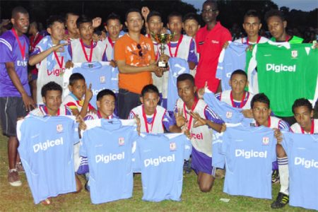 Regional Chairman Paul Pierre handing over the winning trophy to Santa Rosa Secondary while Digicel Head of Customer Care, Sherwin Osbourne (third from right) looks on