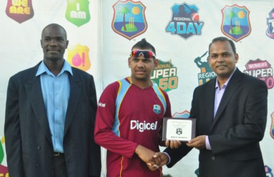 Sunil Narine receiving his man-of-the-match award from Sport Minister Dr Frank Anthony