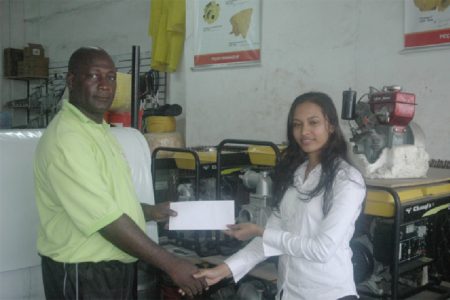 Competitions Director for the Boyce & Jefford Track and Field Classic Mark Scott (left) receives a sponsorship cheque from a representative of four-time sponsors K&B Mining, Seeta Husain.