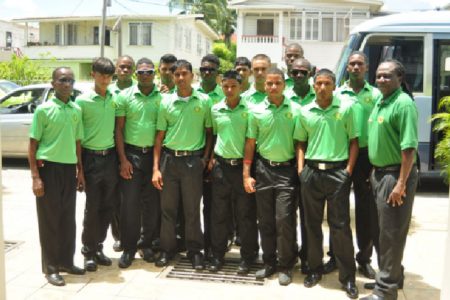  Guyana’s U-19 National team along with Coach Adrian Amsterdam (right) and Manager David Black (left) at the Windjammers Hotel before boarding the bus yesterday morning.