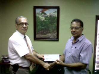 President of the RBC, Brian Allen (right), collecting the sponsorship cheque from Marketing Director of John Fernandes Group, Bernie Fernandes yesterday. 