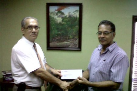 President of the RBC, Brian Allen (right), collecting the sponsorship cheque from Marketing Director of John Fernandes Group, Bernie Fernandes yesterday.
