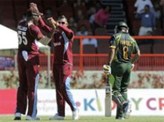 Narine (centre) and Pollard celebrate the fall of another wicket 