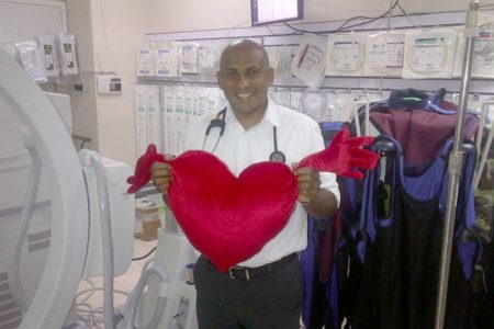 Head of the Caribbean Heart Institute Dr Mahendra Carpen holds up one of the hospital’s heart shaped pillows, a memorabilia given to every patient who undergoes surgery at the institution. He said not only is it illustrative of the love and support the hospital gives to the patient but serves as a reminder of the surgery they underwent so they keep on the prescribed routine given.