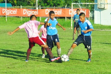 Santa Rosa Secondary and Waramadong Secondary players jostling for possession of the ball