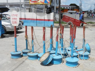 The iron poles and chains which were used as a barricade to cordon off the pavement in front of one business entity