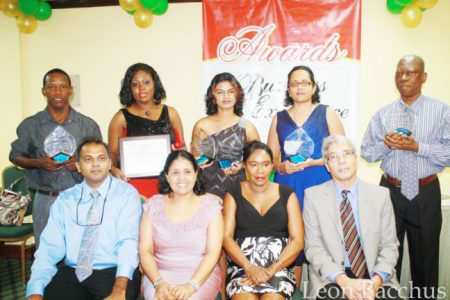 Back row from left: 2013 awardees representing National Milling Company of Guyana Inc, the Guyana Revenue Authority (GRA), Edward B Beharry and Company Ltd, Scotiabank and the GRA. Seated from left: Minister of Culture, Youth and Sport Dr Frank Anthony, NAPS Programme Manager Dr Shanti Singh; Minister of Human Services and Social Security Dr Jennifer Webster and UNAIDS Country Coordinator Dr Roberto Campos