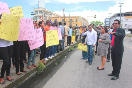 Solidarity: Attorney General Anil Nandlall (right) and Education Minister Priya Manickchand (second from right) lending solidarity to protesters from the Progressive Youth Organization who were lobbying in favour of the Amaila Falls Hydro Power project near parliament today.