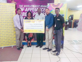 Representatives of the University of Guyana Gwyneth George (second from left) and Phillip DaSilva (centre) being presented with the cheque by Clyde de Haas (second from right), Pernell Cummings (far left) and Kester Abrams (far right)  
