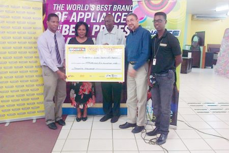 Representatives of the University of Guyana Gwyneth George (second from left) and Phillip DaSilva (centre) being presented with the cheque by Clyde de Haas (second from right), Pernell Cummings (far left) and Kester Abrams (far right)
