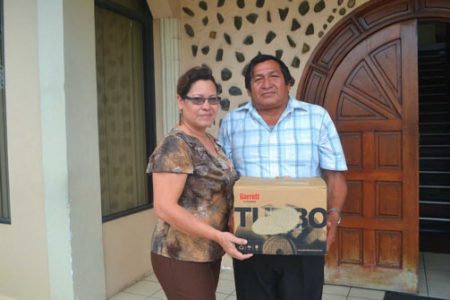 Ministry of Amerindian Affairs, Project Officer, Jude Da Silva (left) handing over the generator part to Toshao, Floyd Edwards of Orealla. (GINA photo)