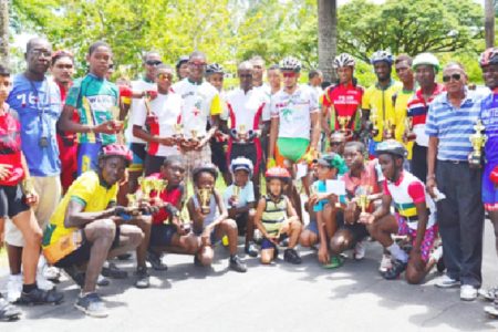 Winners and runners up of the National Sports Commission (NSC) 11-race cycling meet pose with their trophies and prime prizes at the completion of yesterday’s event.