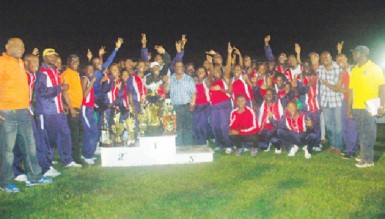 Headquarters athletes celebrate after retaining their title in the Police annual track and field championship last Friday evening at the Police Sports Club ground, Eve Leary.