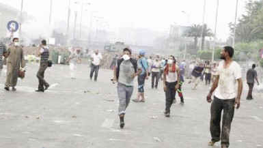  Supporters of ousted President Morsi run from teargas fired by the police in Nasr City, Cairo, yesterday. (Reuters/Asmaa Wagui)