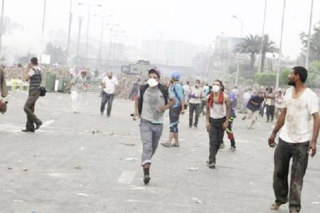  Supporters of ousted President Morsi run from teargas fired by the police in Nasr City, Cairo, yesterday. (Reuters/Asmaa Wagui)