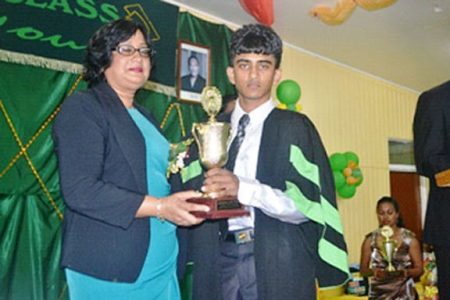 Lalita Baksh presents a trophy to Vishan Persaud from the Mon Repos campus. (GINA photo)
