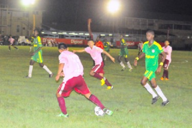 A Waramadong Secondary player battling with a Wismar/Christianburg player for possession of the ball. 