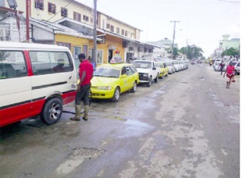 These motorists line up to purchase what is left of the gasoline at Farley’s filling station 