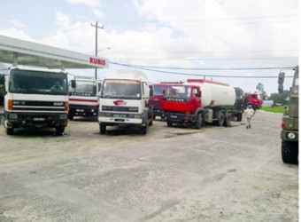 Fuel trucks flock the Rubis fuel storage facility yesterday afternoon to procure whatever fuel they can