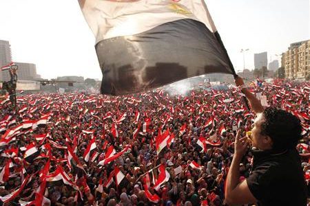 Protesters against Egyptian President Mohamed Mursi wave national flags in Tahrir Square in Cairo July 3, 2013.
REUTERS/Mohamed Abd El Ghany